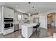 Modern kitchen with white cabinets, stainless steel appliances, and an island at 5732 Cypress Bluff Ln, Hoschton, GA 30548
