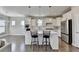 Modern kitchen with white cabinets, island, and stainless steel appliances at 5732 Cypress Bluff Ln, Hoschton, GA 30548