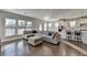 Open concept living room and kitchen with hardwood floors and sectional sofa at 5732 Cypress Bluff Ln, Hoschton, GA 30548