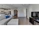Open concept living room with hardwood floors and views into the kitchen at 5732 Cypress Bluff Ln, Hoschton, GA 30548