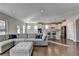 Open concept living room and kitchen with hardwood floors and sectional sofa at 5732 Cypress Bluff Ln, Hoschton, GA 30548
