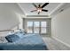 Bright main bedroom with carpeted floors and large windows at 5732 Cypress Bluff Ln, Hoschton, GA 30548
