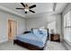 Main bedroom with carpeted floors, ceiling fan and access to bathroom and walk-in closet at 5732 Cypress Bluff Ln, Hoschton, GA 30548