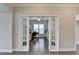 Home office with French doors, hardwood floors, and built-in desk at 5732 Cypress Bluff Ln, Hoschton, GA 30548