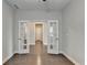 Home office with French doors opening to hallway at 5732 Cypress Bluff Ln, Hoschton, GA 30548