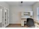 Home office with built-in desk and French doors at 5732 Cypress Bluff Ln, Hoschton, GA 30548