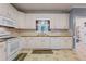 Kitchen with white cabinets and tile flooring at 1302 Eddie Craig Ct, Mcdonough, GA 30252