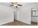 Bedroom with wood-look floors, ceiling fan, and access to bathroom at 7270 Crestside Dr, Austell, GA 30168