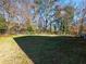 Backyard with a grassy area and trees at 488 Village Run, Lawrenceville, GA 30046