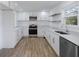 Modern kitchen with white cabinets, stainless steel appliances, and quartz countertops at 488 Village Run, Lawrenceville, GA 30046