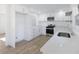 Modern kitchen with white cabinets, stainless steel appliances, and quartz countertops at 488 Village Run, Lawrenceville, GA 30046