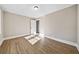 Simple bedroom with neutral walls, wood-look floors, and a window at 996 Marietta Rd, Canton, GA 30114