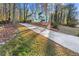 House exterior view, showcasing a long driveway leading to a two-story home at 2987 Forest Chase Ne Ter, Marietta, GA 30066