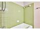 Green tiled bathroom with shower/tub combo at 3740 Douglas Ridge Trl, Douglasville, GA 30135