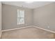 Spacious bedroom with a large window and neutral decor at 516 Towler Shoals Vw, Loganville, GA 30052