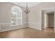 Elegant dining room with chandelier, hardwood floors, and wainscoting at 516 Towler Shoals Vw, Loganville, GA 30052