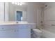 Clean bathroom with white vanity, toilet, and shower/tub combo at 1987 Ridge Water Ln, Lawrenceville, GA 30045