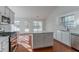 Bright kitchen with island, hardwood floors, and access to backyard at 1987 Ridge Water Ln, Lawrenceville, GA 30045