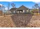 Large, fenced backyard with a covered patio and trees at 201 Mcgarity Rd, Temple, GA 30179