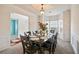 Dining room with dark wood table, seating for eight, and a view to an adjacent room at 4975 Burberry Way, Fairburn, GA 30213