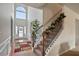 Foyer with hardwood floors, staircase with decorative railing, and a large window at 4975 Burberry Way, Fairburn, GA 30213