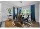 Bright dining room features a glass table, four chairs, and teal curtains at 524 Glen Abbey Cir, Mableton, GA 30126