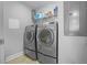 Bright laundry room with washer and dryer and extra shelving at 524 Glen Abbey Cir, Mableton, GA 30126