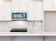 Modern kitchen with stainless steel appliances and white shaker cabinets at 695 Sunstone Ln, Lawrenceville, GA 30043