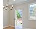 Dining room with hardwood floors, chandelier, and access to backyard patio at 693 Sunstone Ln, Lawrenceville, GA 30043