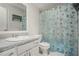 Bathroom with a shower/tub combo, white vanity, and decorative shower curtain at 850 Kenwood Ln, Jonesboro, GA 30238