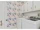 Laundry room with washer, dryer, and stylish wallpaper at 260 Manning Sw Rd # 62, Marietta, GA 30064