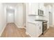 Modern kitchen with white cabinets, stainless steel appliances and quartz countertops at 691 Sunstone Ln, Lawrenceville, GA 30043