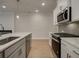 Modern kitchen with white cabinets and a quartz island at 689 Sunstone Ln, Lawrenceville, GA 30043