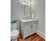 Elegant powder room features a white vanity, marble countertop, and hardwood floors at 3403 Tuxedo Nw Rd, Atlanta, GA 30305