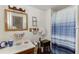 Bathroom with shower, oak cabinet, and tile floors at 4571 Bennett Rd, Buford, GA 30519