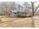 Charming single-story home with a metal roof, front porch, and teal door at 4571 Bennett Rd, Buford, GA 30519