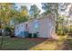 Side view of a newly painted brick ranch home with a red door and landscaping at 640 Steve Sw Dr, Atlanta, GA 30315