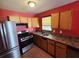 Galley kitchen with stainless steel appliances and wood cabinets at 3436 Adkins Rd, Atlanta, GA 30331