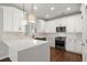 Modern kitchen with white cabinets, quartz countertops, and a farmhouse sink at 4618 Liberty Square Dr, Acworth, GA 30101