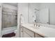 Bright bathroom with white vanity, bathtub, and shower at 1376 Oak Grove Dr, Decatur, GA 30033