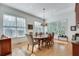 Sunlit dining room with hardwood floors, chandelier, and large windows at 1376 Oak Grove Dr, Decatur, GA 30033