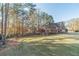 Brick house exterior with large backyard and mature trees at 2590 Hidden Wood Ln, Lawrenceville, GA 30043