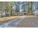 Ranch home with a paved driveway and wooded backyard at 1374 Margarette Dr, Decatur, GA 30035