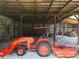 Spacious barn interior with tractor and farm equipment at 4079 Bullock Bridge Rd, Loganville, GA 30052