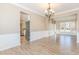 Formal dining room with hardwood floors, chandelier, and kitchen view at 4159 Berwick Farm Dr, Duluth, GA 30096