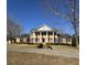 Brick home with a grand entrance, columns, and a manicured lawn at 3637 Linda Dr, Loganville, GA 30052