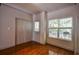 Bright bedroom with hardwood floors, double doors, and a view of the backyard at 3064 Lauren Parc Rd, Decatur, GA 30032