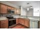 Modern kitchen with stainless steel appliances and wood cabinets at 3064 Lauren Parc Rd, Decatur, GA 30032