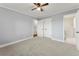 Spacious bedroom with neutral walls, carpet, and double doors to bathroom at 3765 Cindy Dr, Douglasville, GA 30135