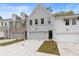 Two-story townhome with gray and white brick exterior, two-car garage, and landscaped front yard at 687 Sunstone Ln, Lawrenceville, GA 30043